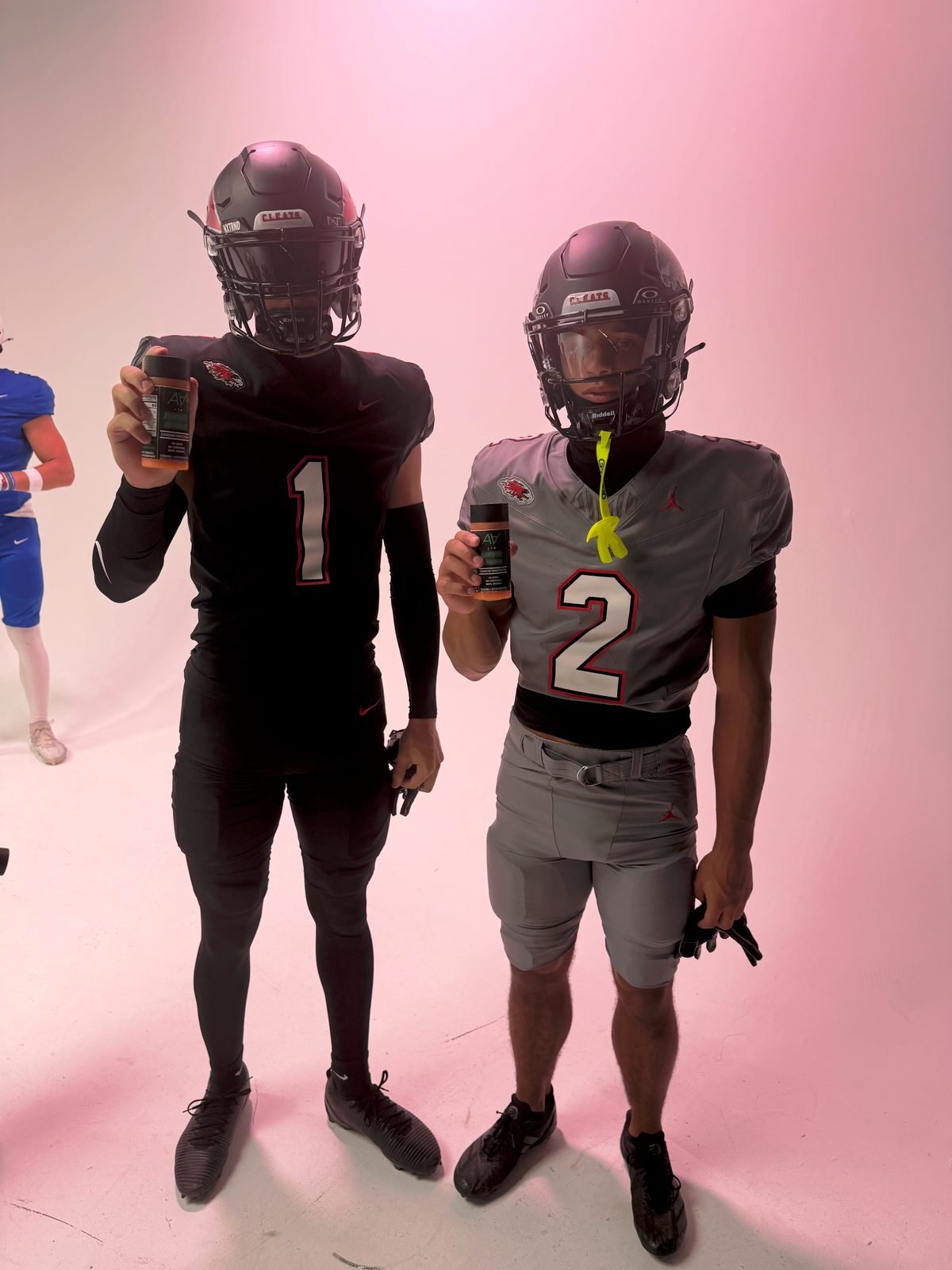 Football players in helmets with Alkaline Activated
