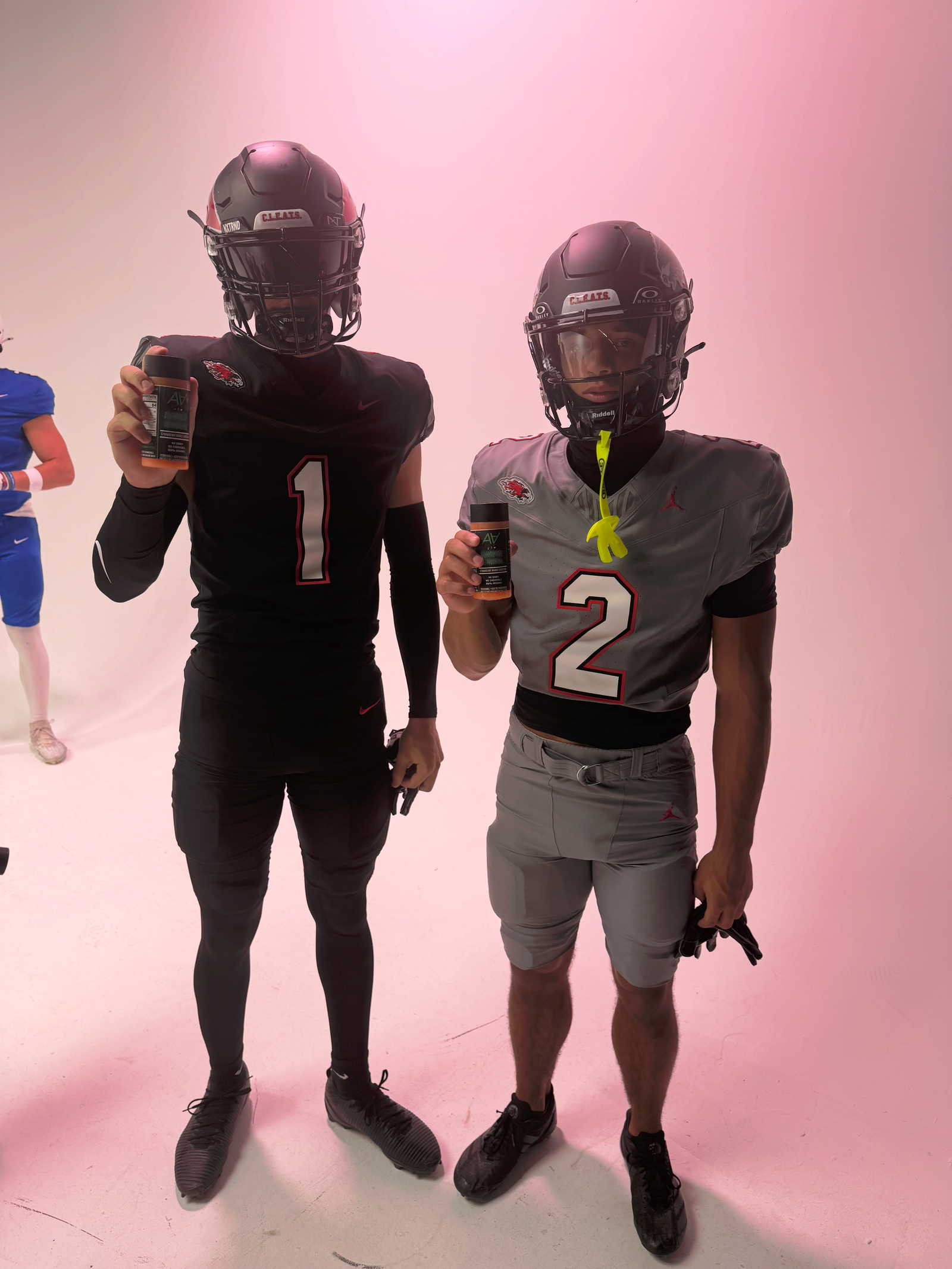 Football players in helmets with Alkaline Activated